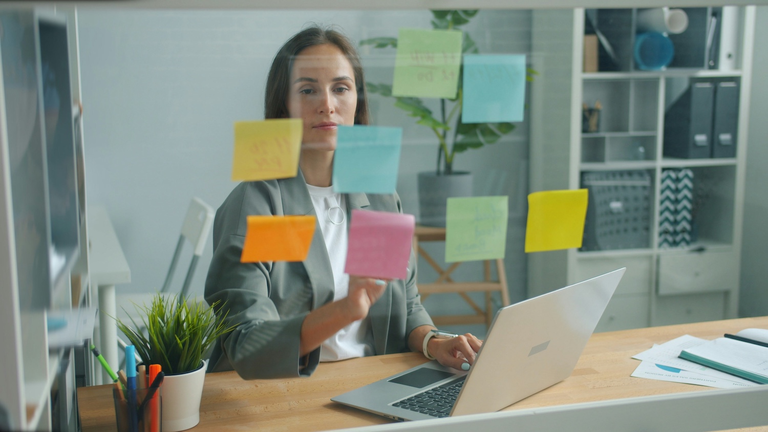 woman at desk with post-its